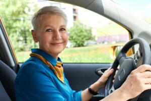 middle age woman driving a car